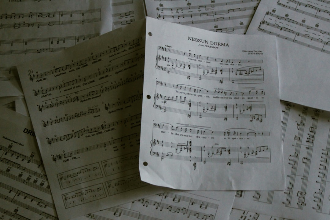 About a-pile-of-sheet-music-sitting-on-top-of-a-table-iglbkedmql4