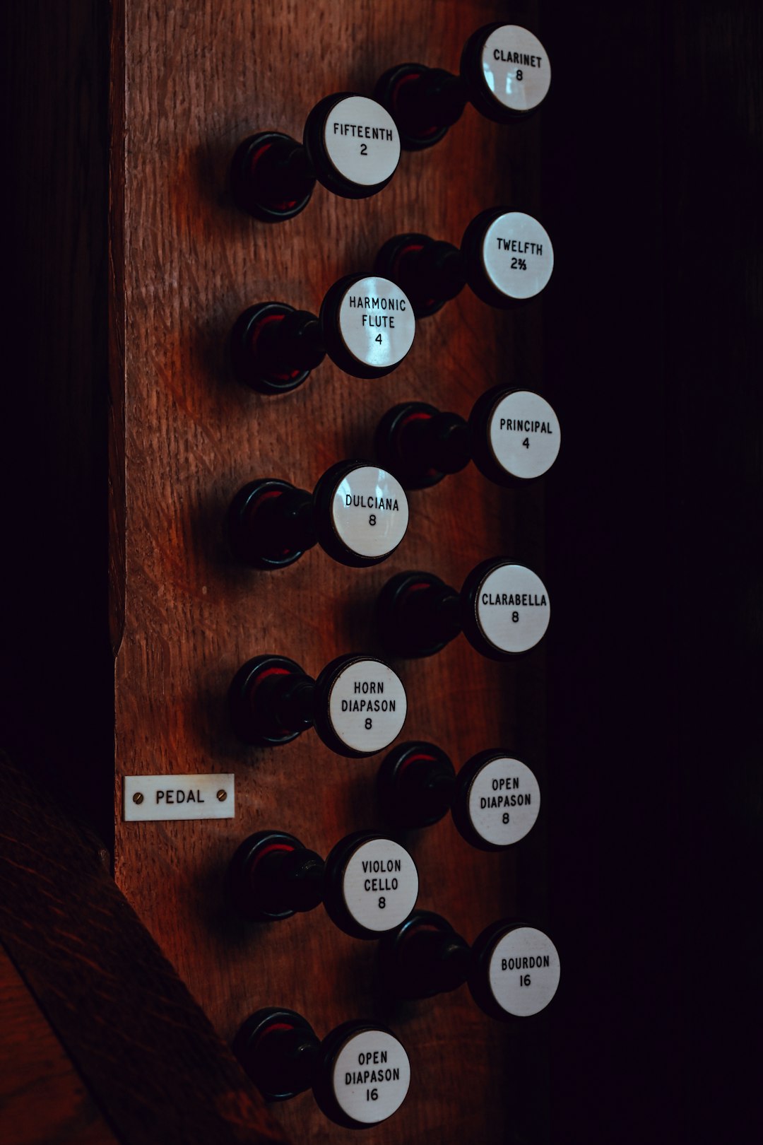 Services organ-stops-with-labels-on-wooden-panel-sxvtz2gnxb4
